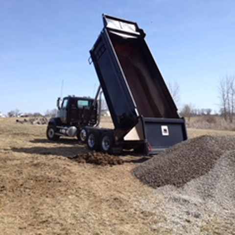 dump truck with rock piles