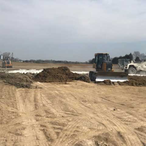 plot of flat land with excavator